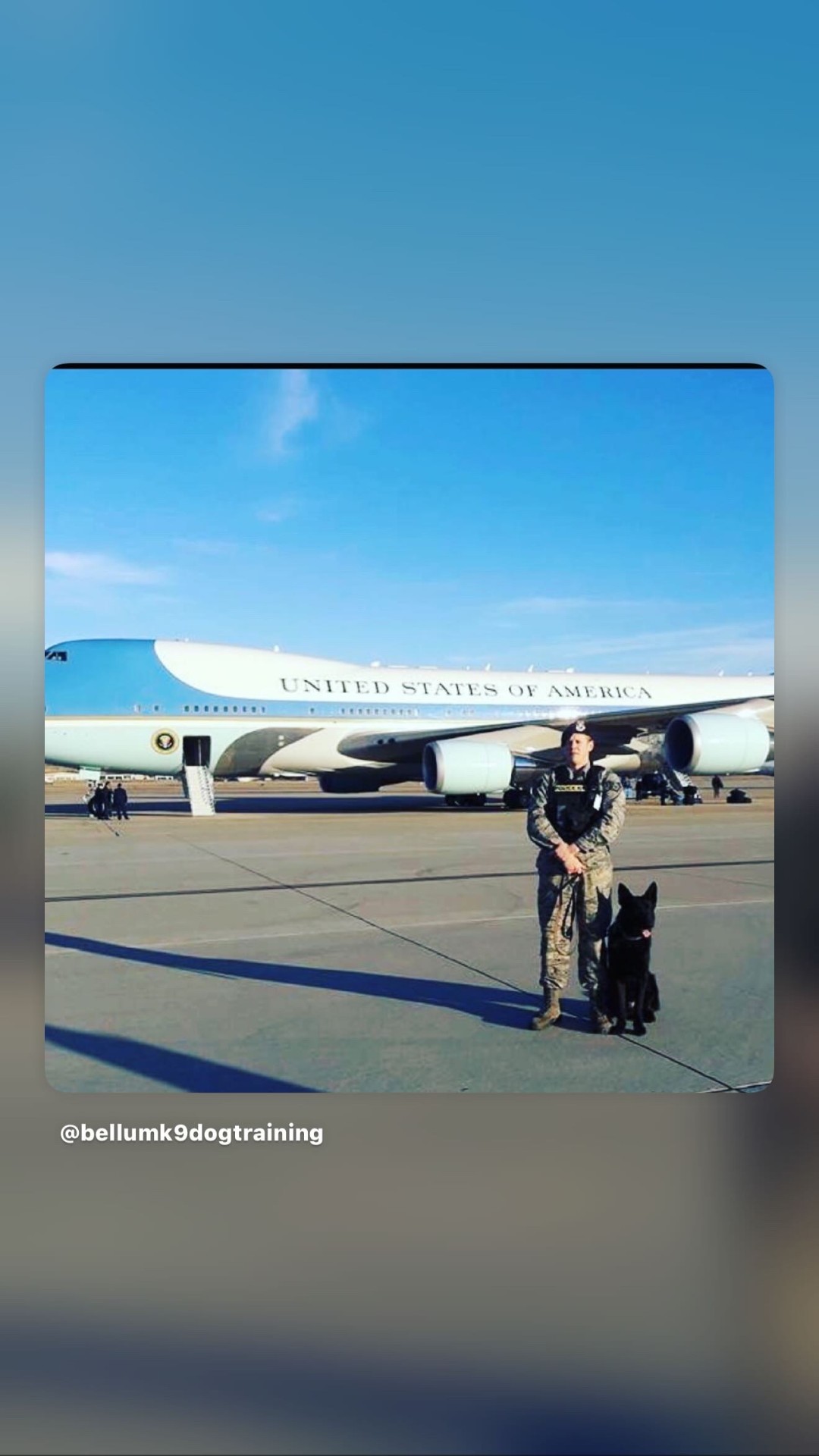 Shane McNamara in USAF Security Forces uniform with his K9 partner on the flightline in front of Air Force One